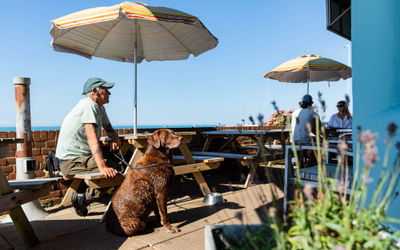 guy sitting with his dog in Roedean Garden