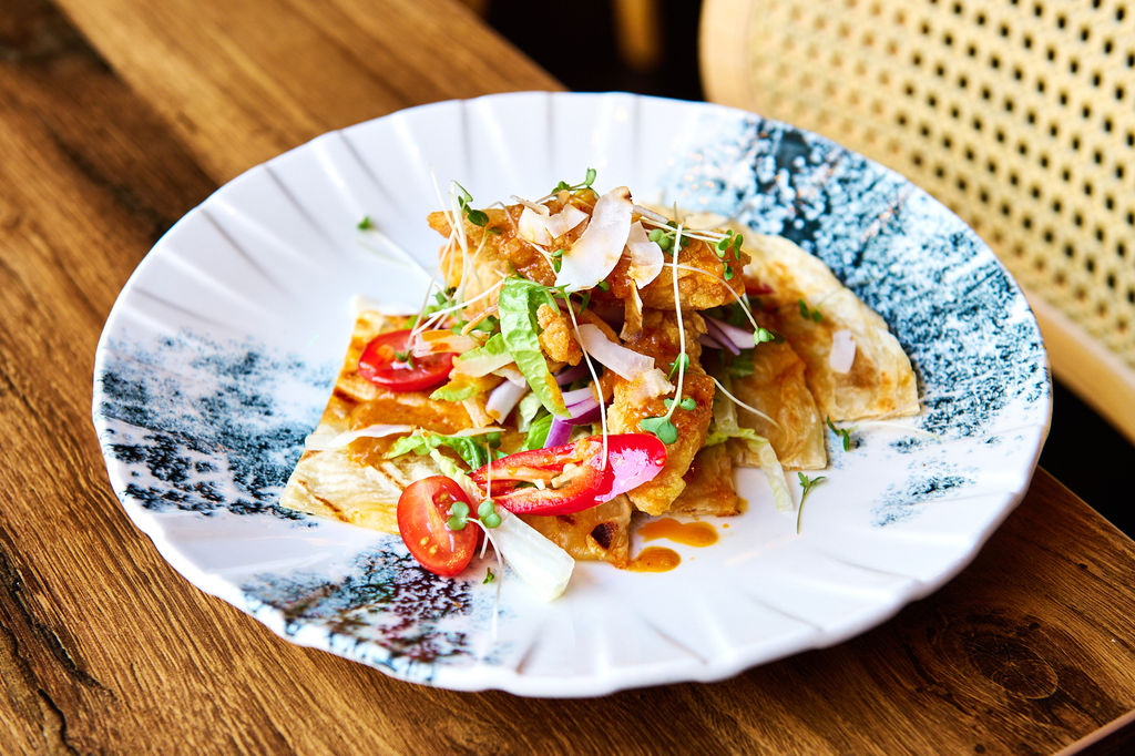 Colourful Prawn satay roti dish on a white plate with a charcoal glaze pattern.
