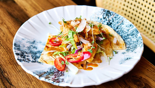 Colourful Prawn satay roti dish on a white plate with a charcoal glaze pattern.