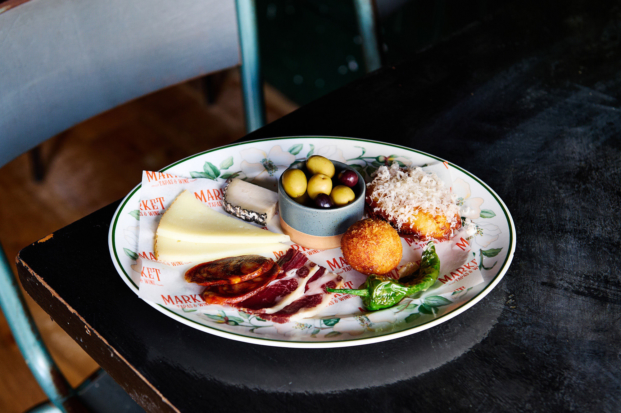 ‘A Taste of Market’ seasonal tapas selection on a dark wooden table.