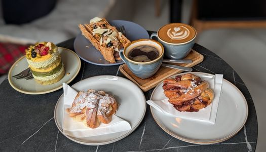 cakes, pastires and two coffee served on the table at Jacobs Bakery