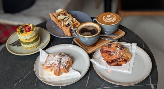 cakes, pastires and two coffee served on the table at Jacobs Bakery
