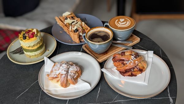 cakes, pastires and two coffee served on the table at Jacobs Bakery