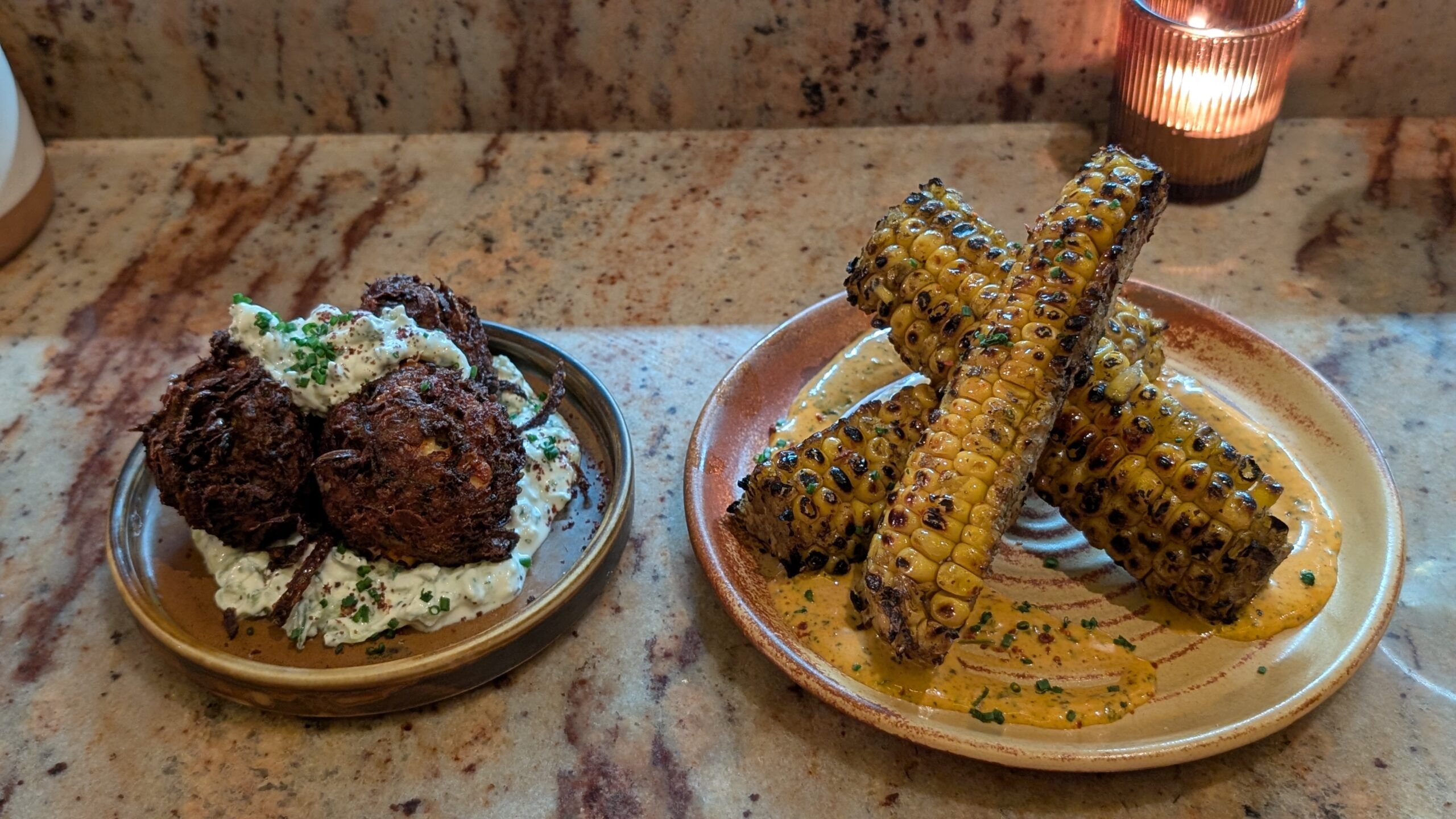 courgette and feta fritters served with tzatziki and sumac, and chargrilled corn ribs with sriracha mayo.