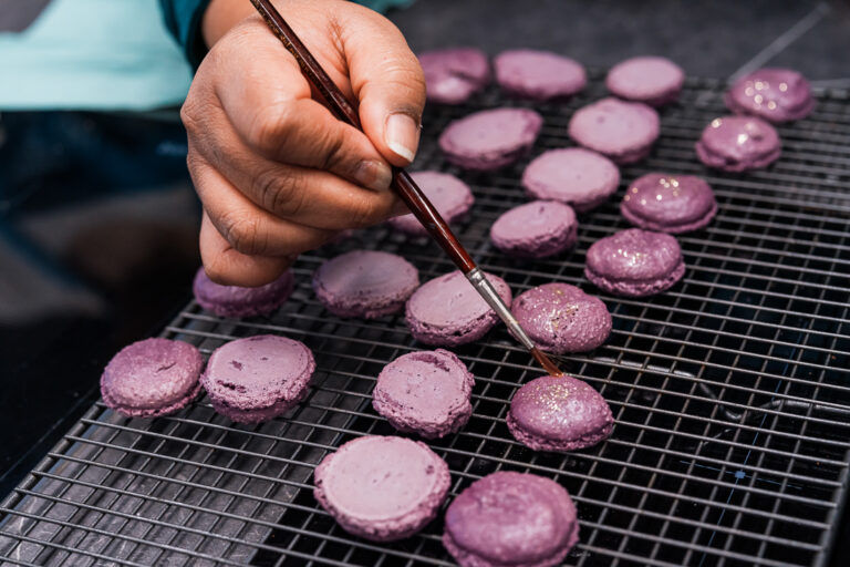 macarons being colored purple at cooking classes