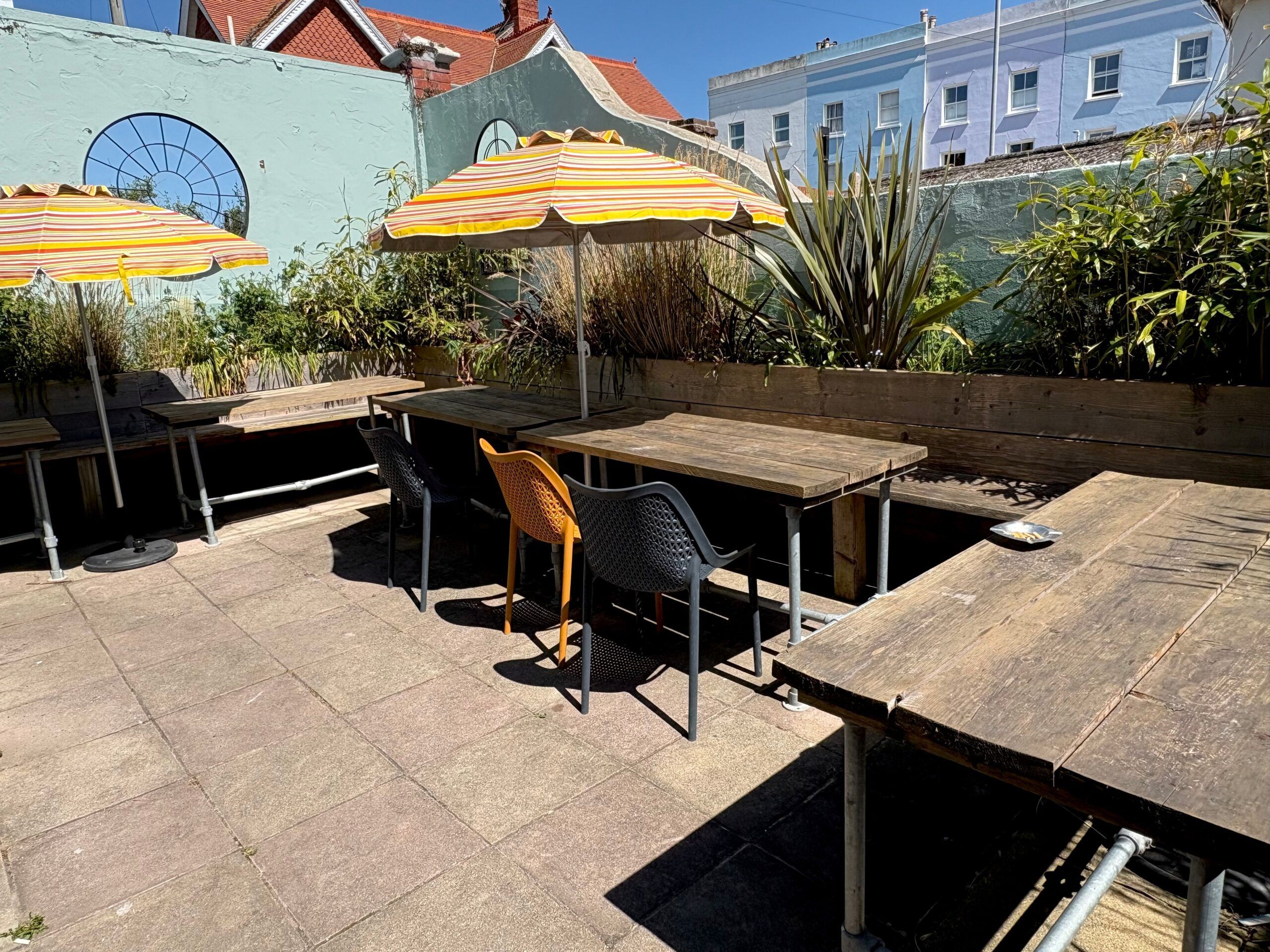 Mac's Cafe garden with tables and umbrellas