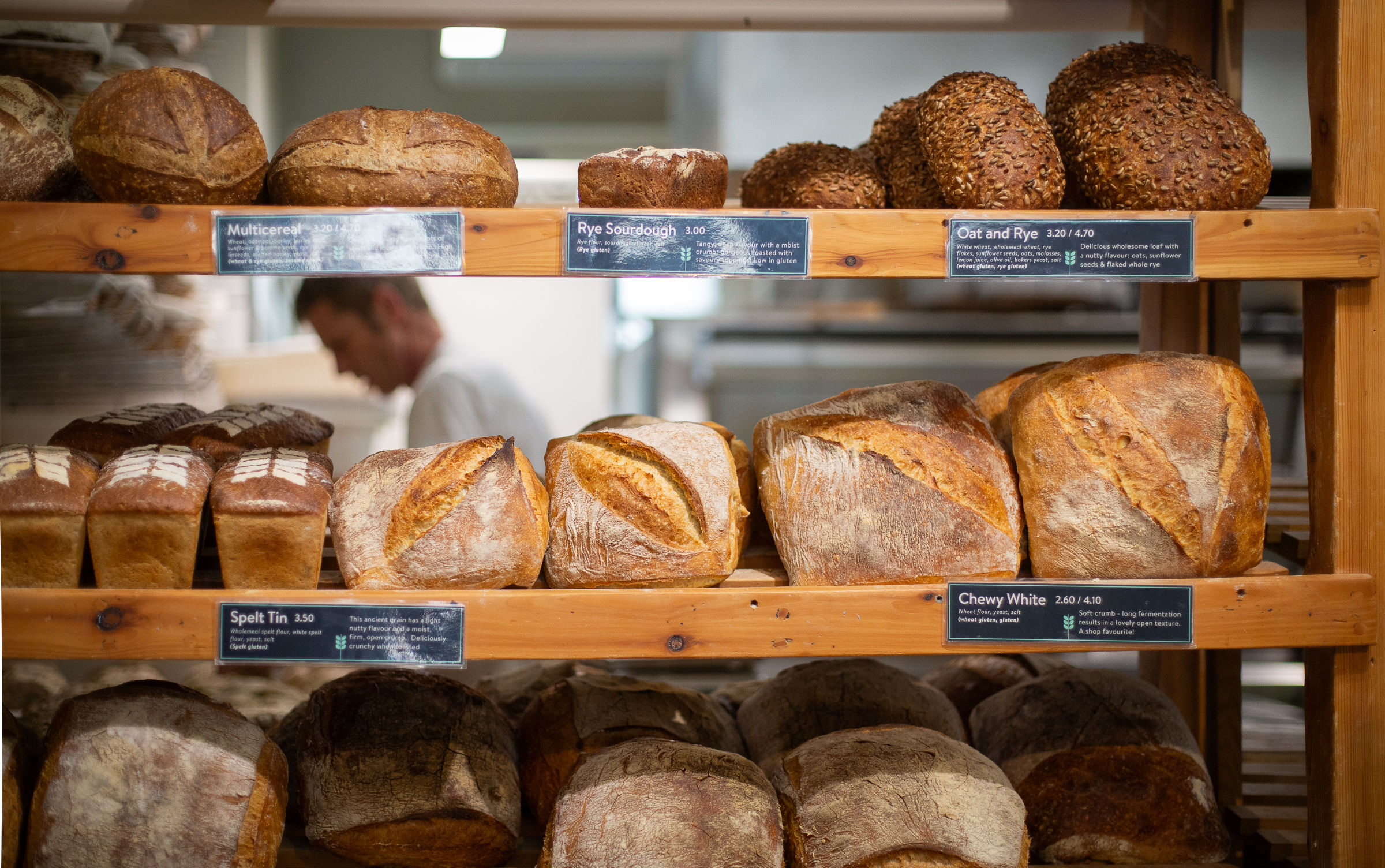 Loaves of bread on a shelf at Open Bakery Brighton. three shelves of goodies
