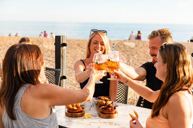 Where to celebrate the Brighton Bank Holiday weekend. Pictured, diners enjoying a sundowner at OhSo social on Brighton beach.