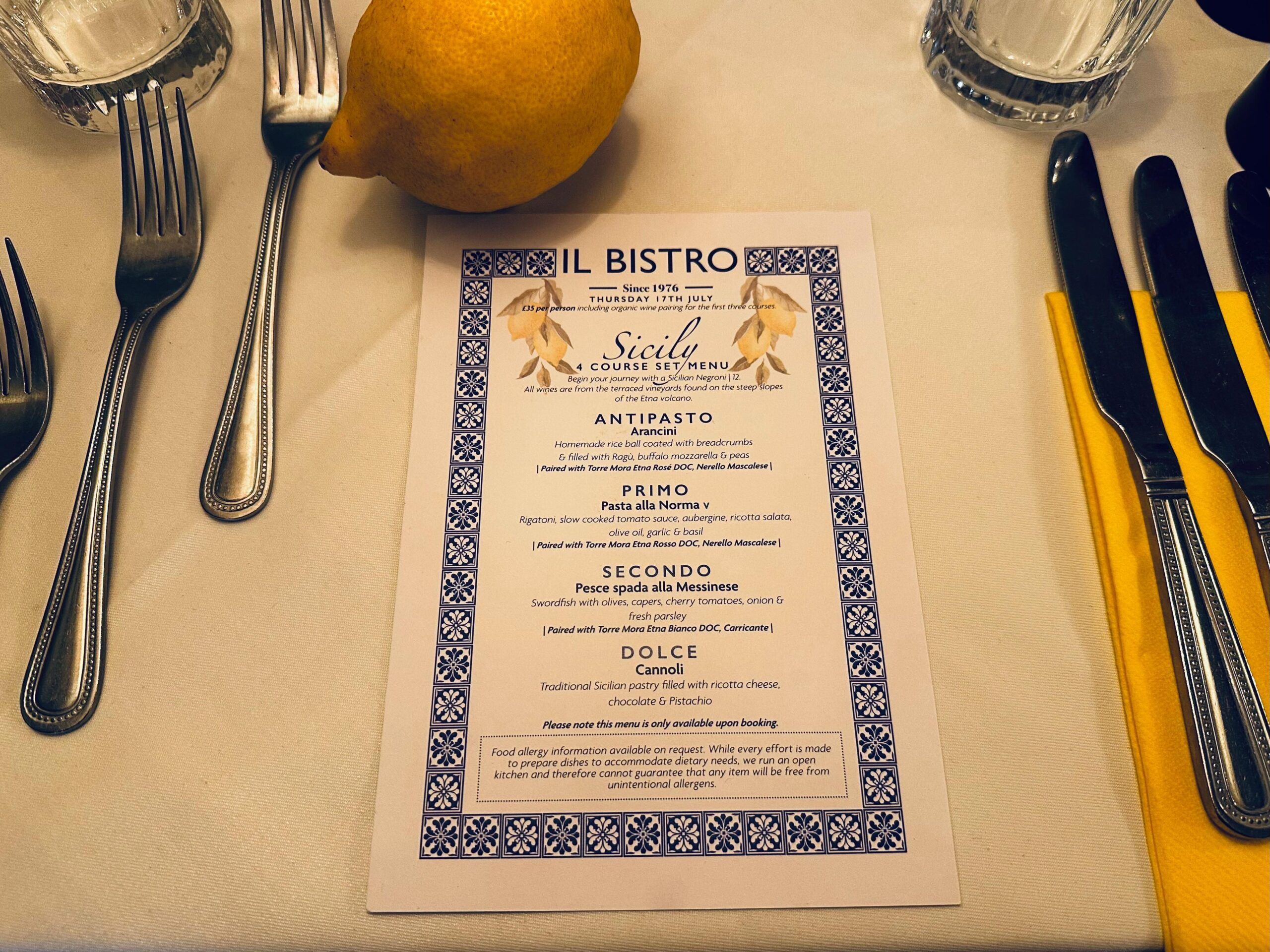 over head shot of the menu A taste of Sicily, cutlery and lemon at the Il Bistro Table,