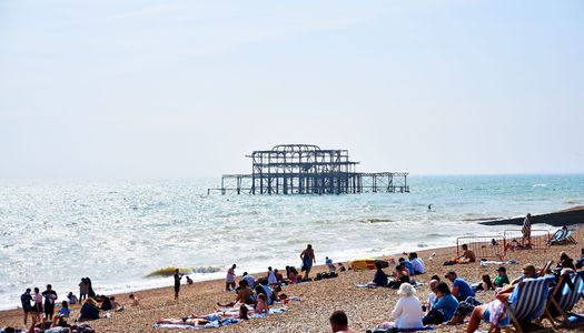 Brighton Beach - West Pier - people laying on the beach