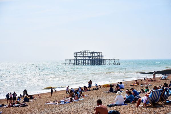 Brighton Beach - West Pier - people laying on the beach