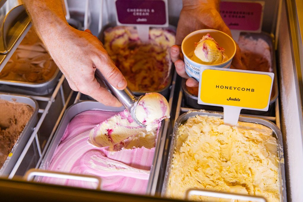 hand scooping ice cream from ice cream boxes at Met
