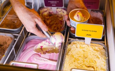hand scooping ice cream from ice cream boxes at Met