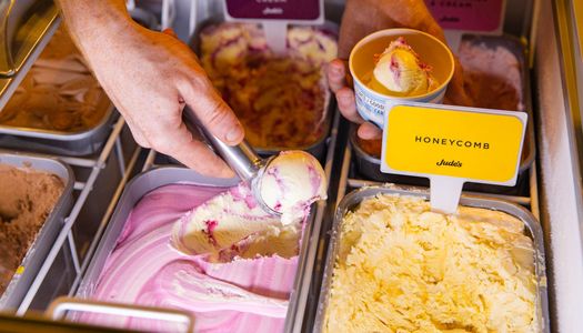 hand scooping ice cream from ice cream boxes at Met