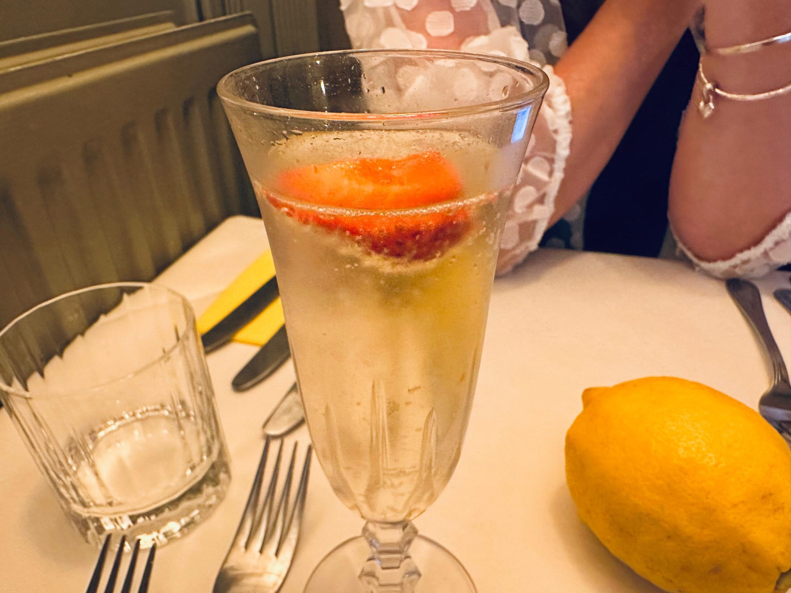 glass of prossecco with the strawberry at the top