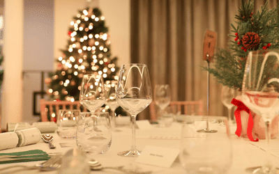 table set up for a lunch, Christmas tree in the background