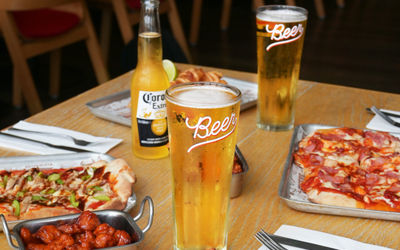 Table set with food and drinks at Bench Sports Bar in Brighton.