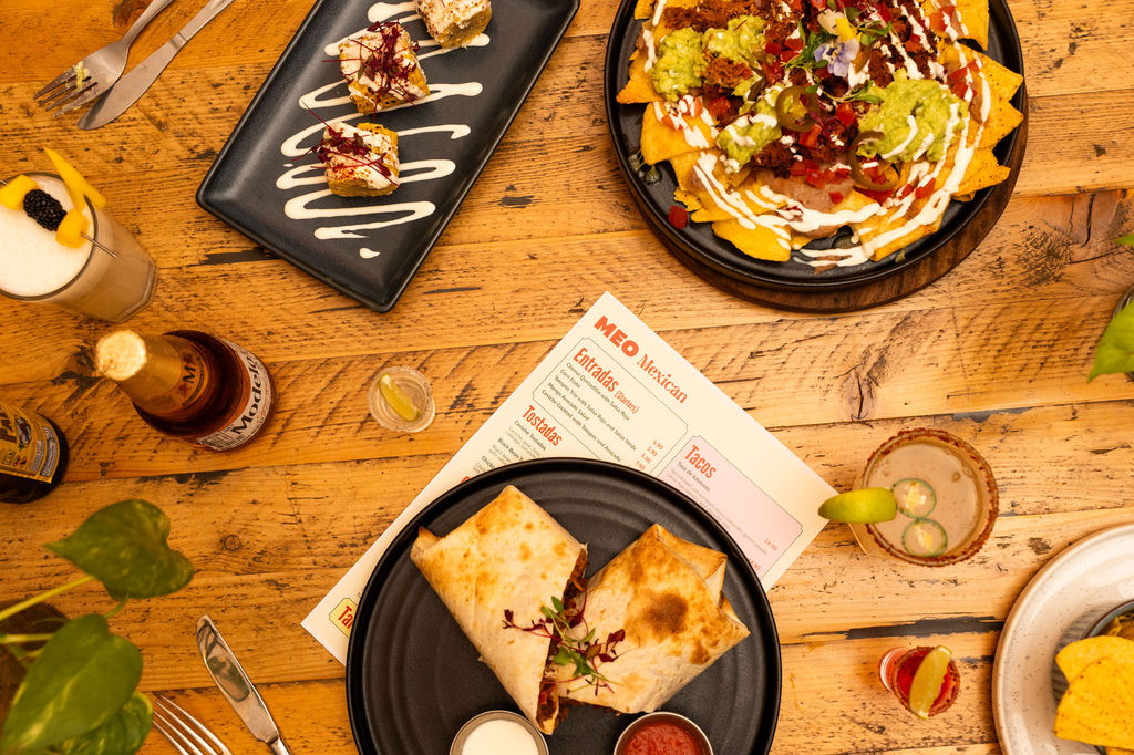 A table of Mexican food and cocktails at MEO