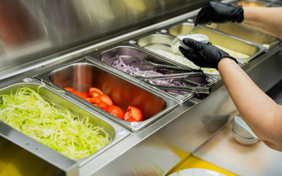 metal boxed filled with different veggies in the kitchen at Parthenon Gyros Brighton