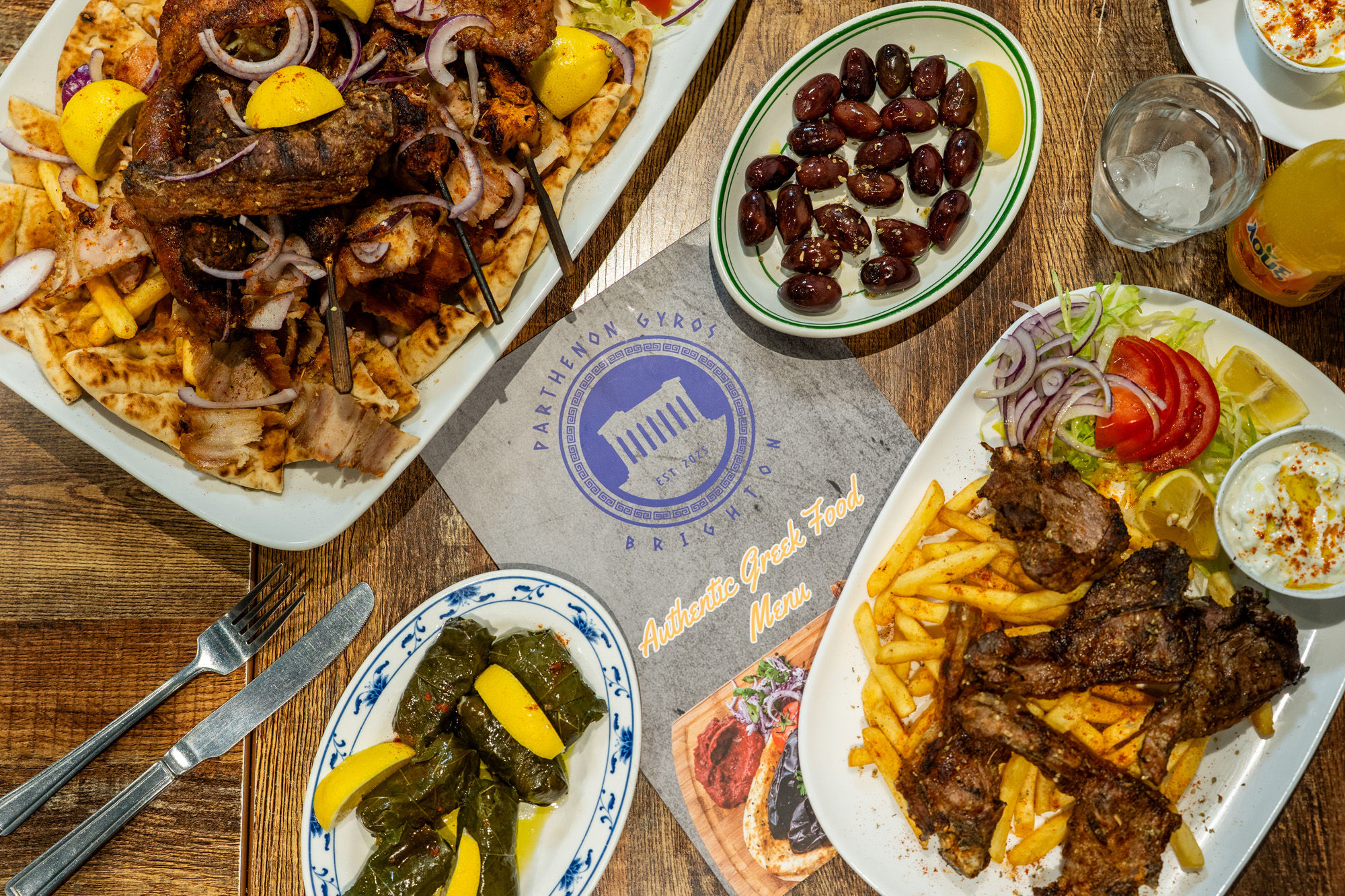 over head shot of the two platters for sharing with sides and the menu in the middle at Parthenon Gyros