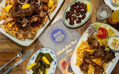 over head shot of the two platters for sharing with sides and the menu in the middle at Parthenon Gyros