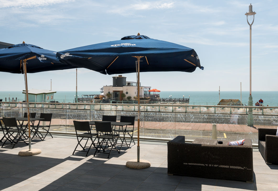 Terrace seating area at Bench Sports Bar in Brighton overlooking the sea.