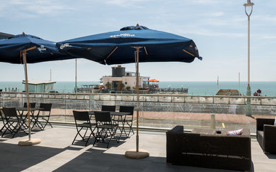 Terrace seating area at Bench Sports Bar in Brighton overlooking the sea.