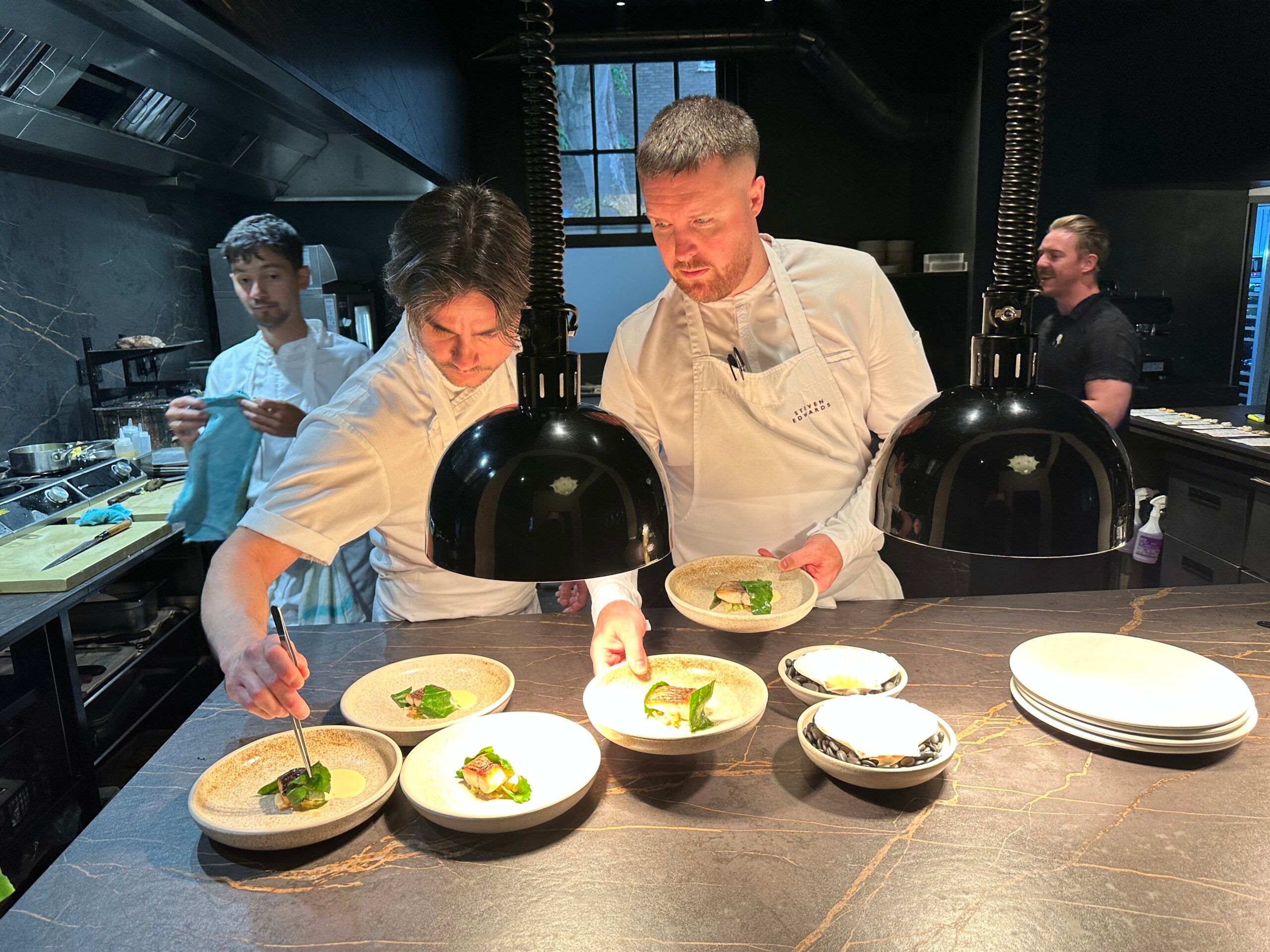 chefs preparing food in the kitchen