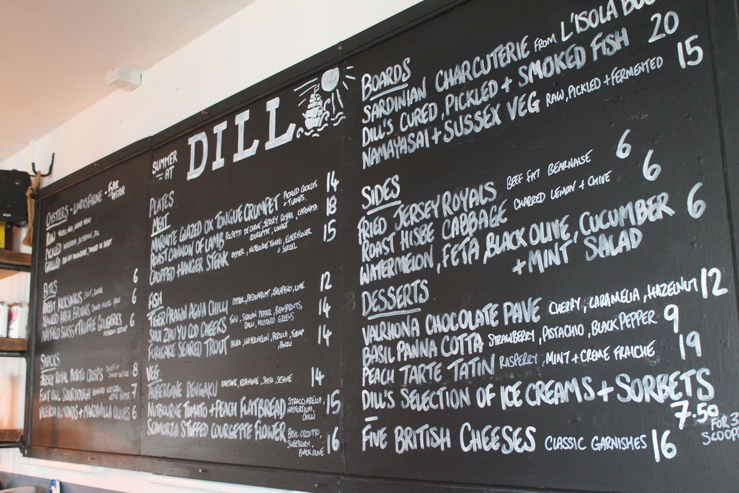 chalkboard with menu on it at Dill restaurant