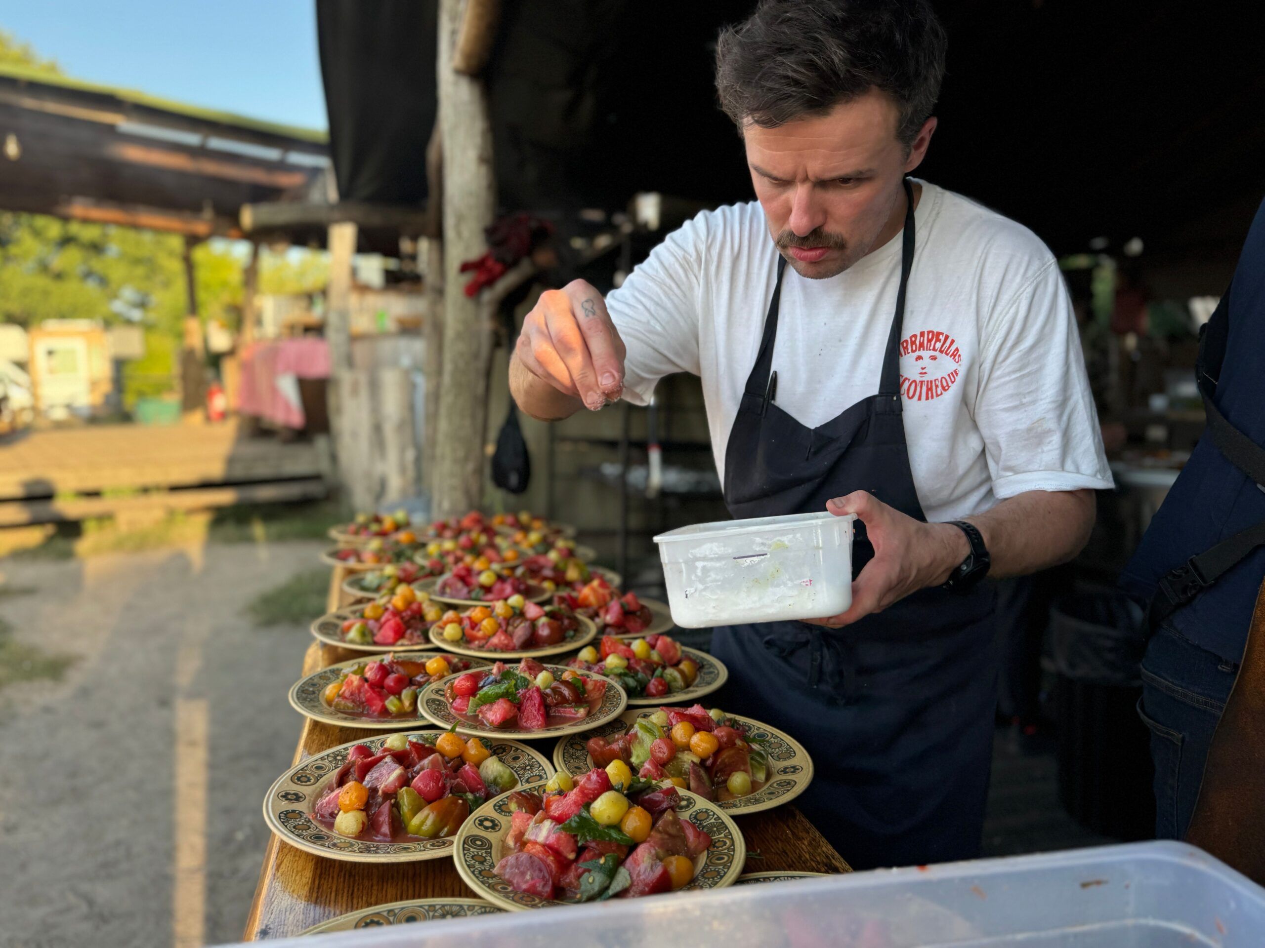 Chef seasoning food on the plates