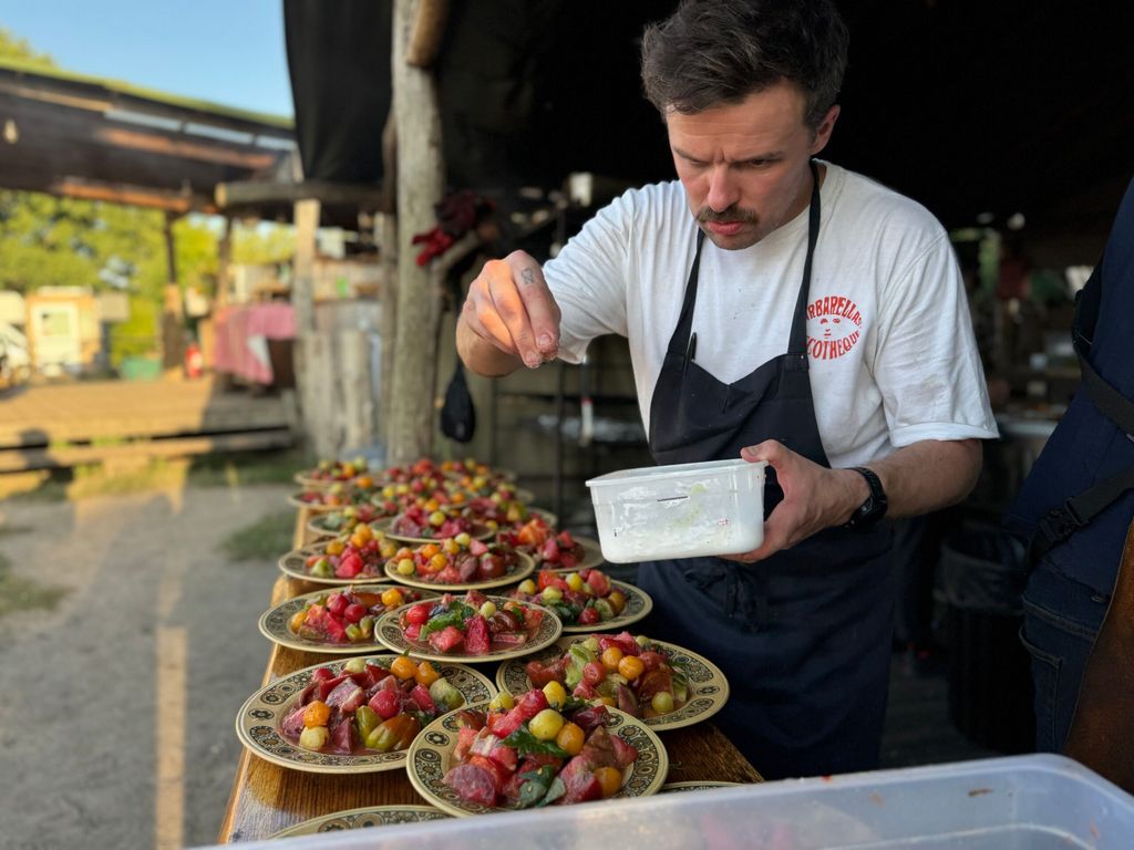 Chef seasoning food on the plates