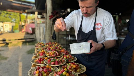 Chef seasoning food on the plates