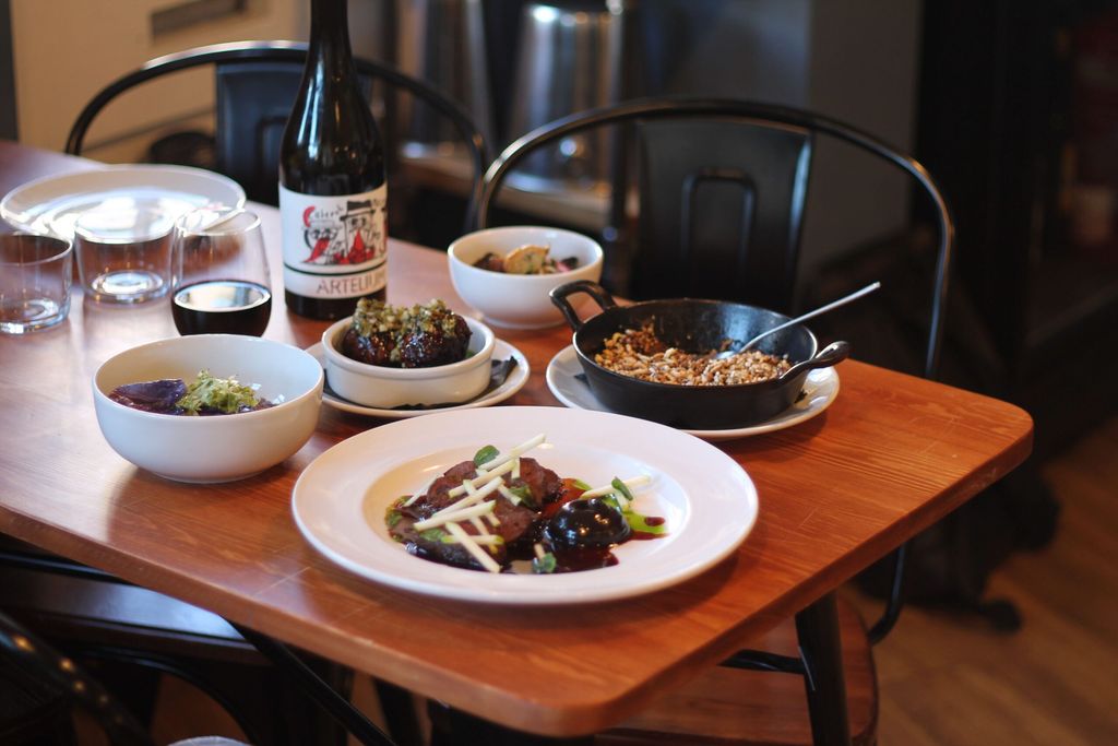 side shot of the table laid out with small plates and dishes at Dill Lewes