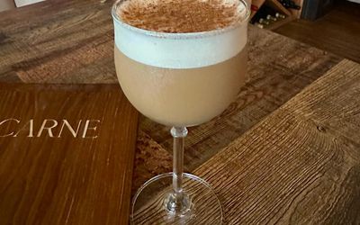 brown cocktail with foam on the top