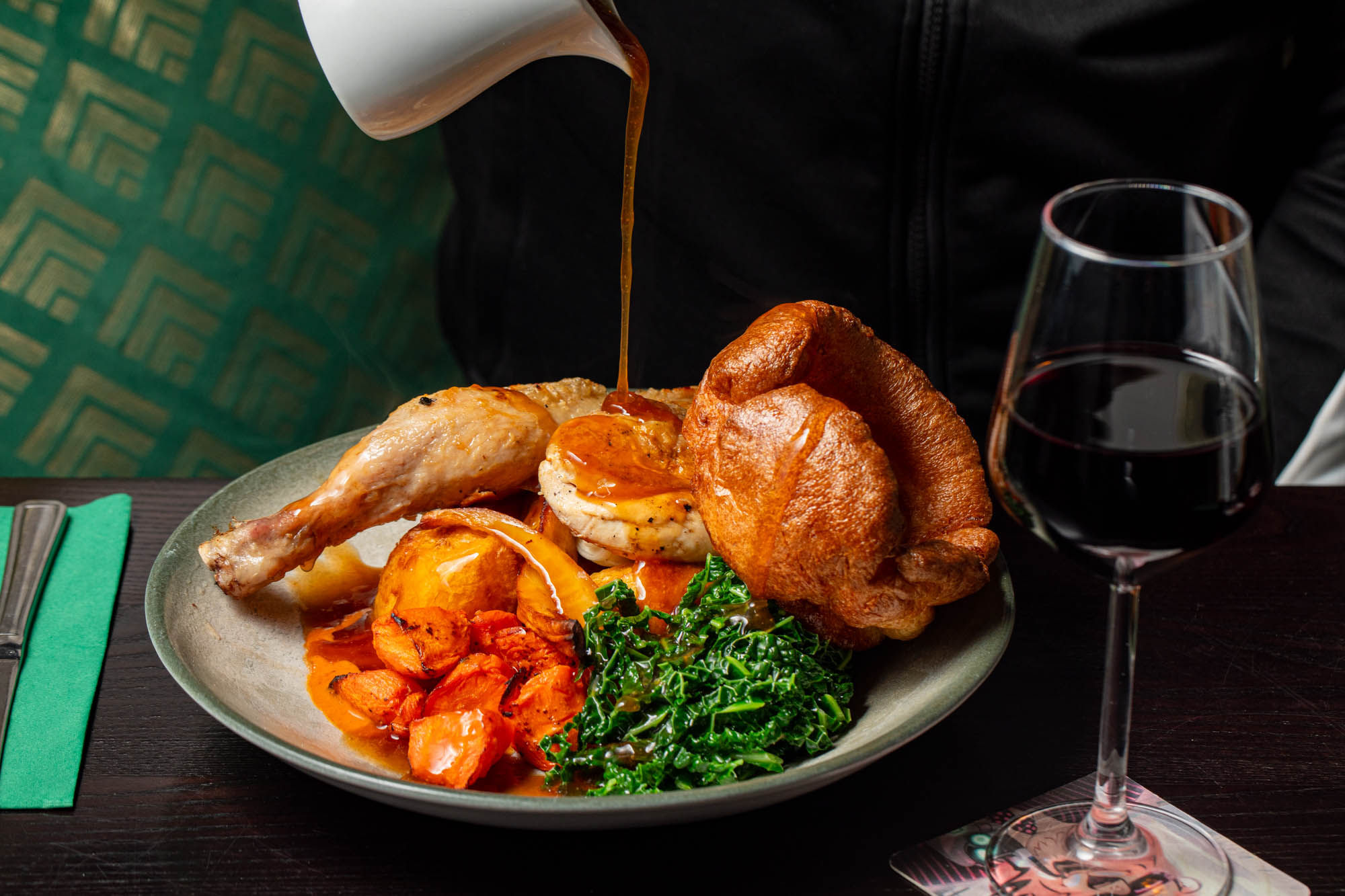 shot of the gravy being poured on sunday roast at the bell tower