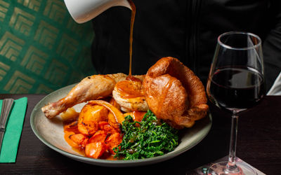 shot of the gravy being poured on sunday roast at the bell tower