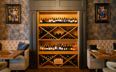 Carne Hove - photo of the wooden shelves populated with various wines