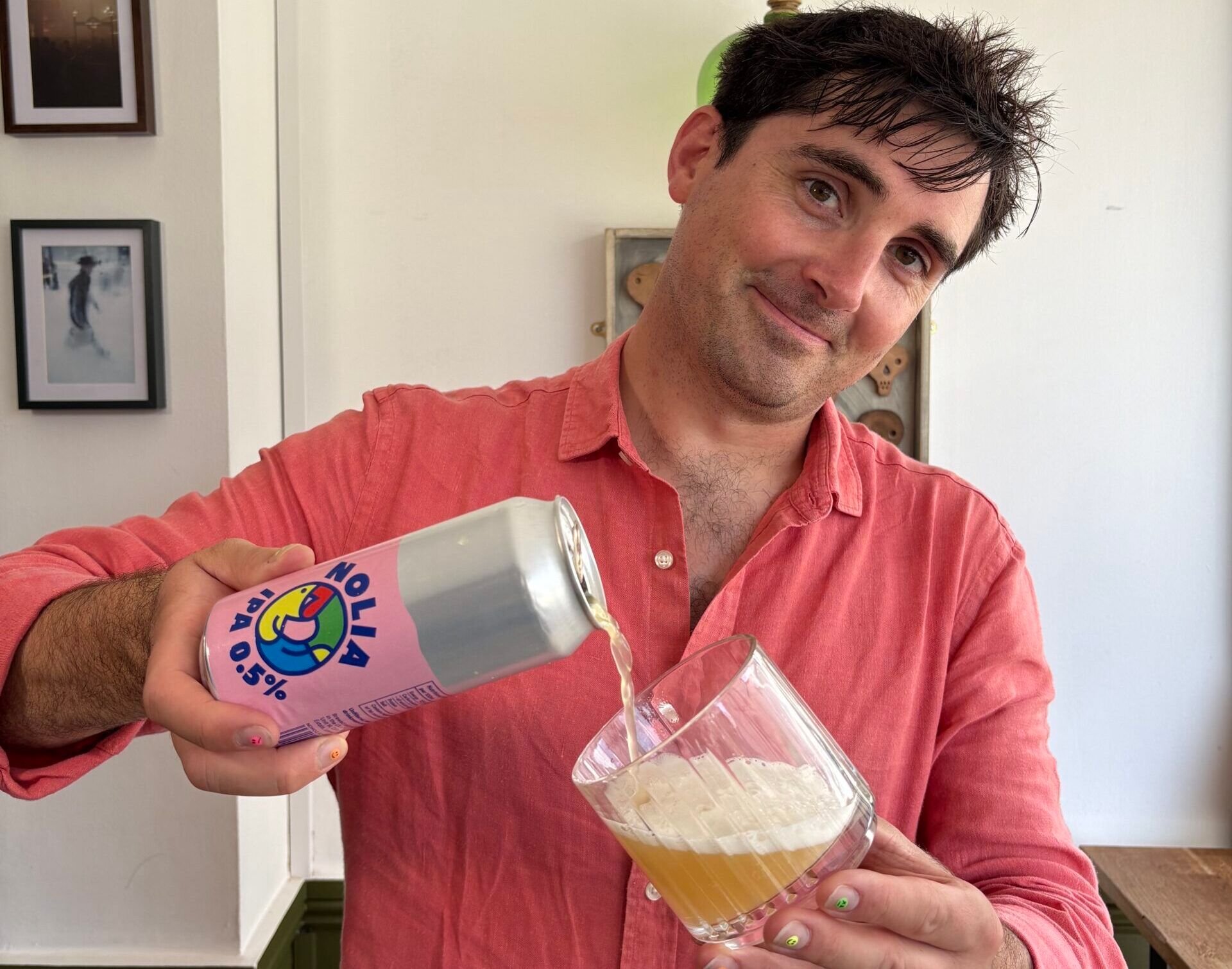 Tom Surgey sipping beer into glass