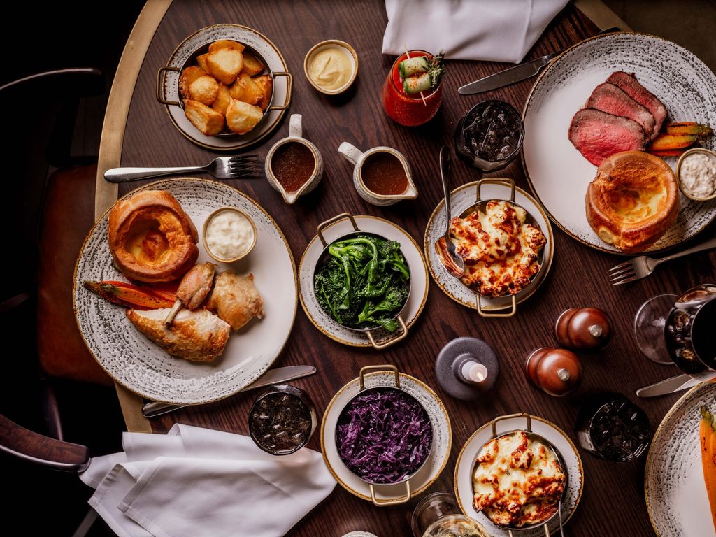 over head shots of the table populated with Sunday Roast dishes at Pearly Cow
