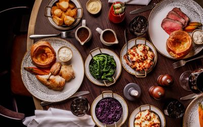 over head shots of the table populated with Sunday Roast dishes at Pearly Cow