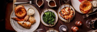 over head shots of the table populated with Sunday Roast dishes at Pearly Cow