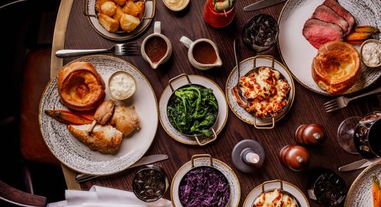 over head shots of the table populated with Sunday Roast dishes at Pearly Cow