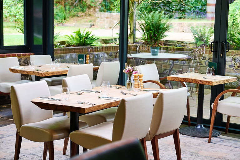 Tables set up in the conservatory in the Sussex pub The Jolly Sportsman.