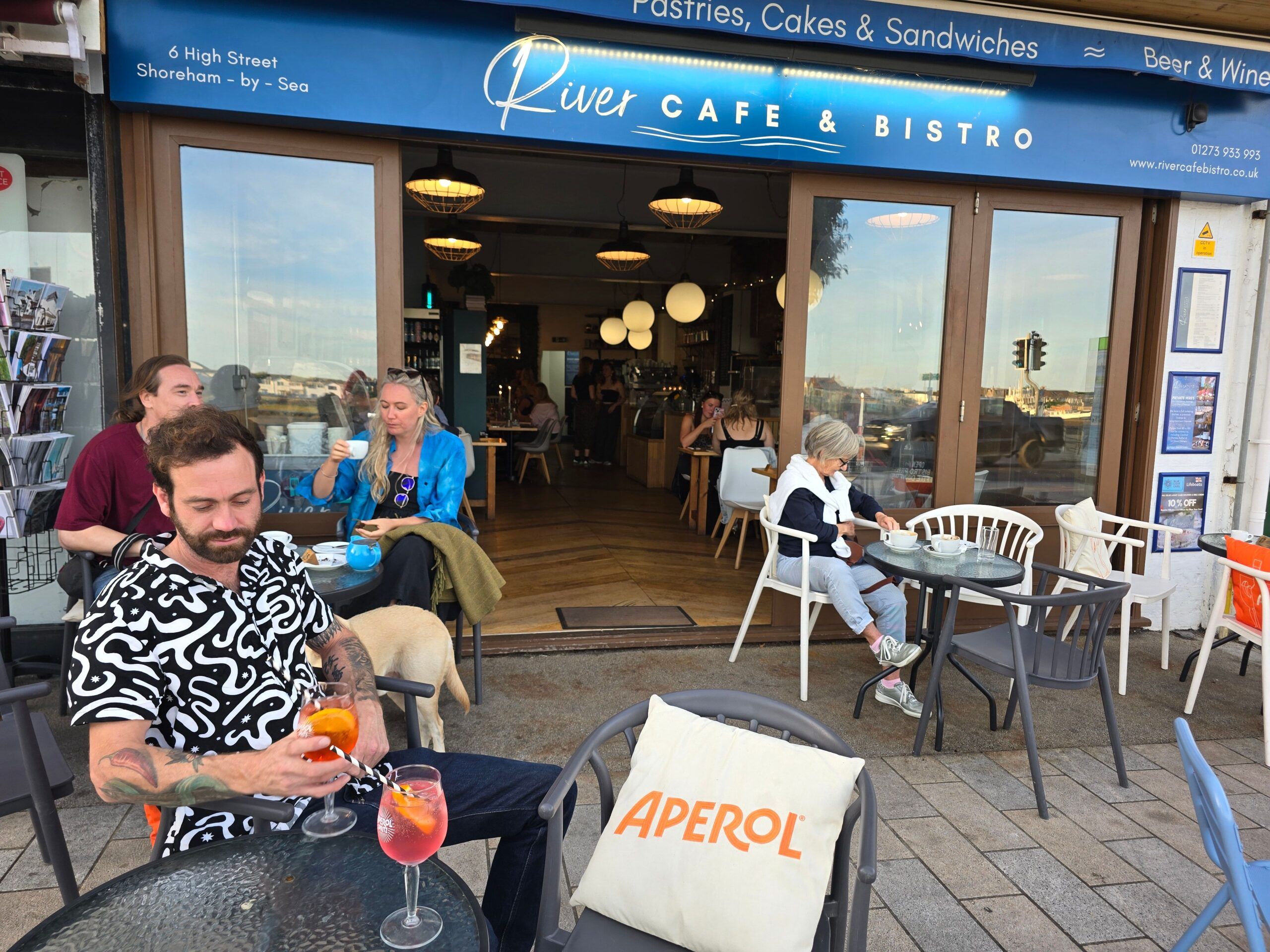 Jessicas partner drinking aperol spritz outside the cafe and bistro