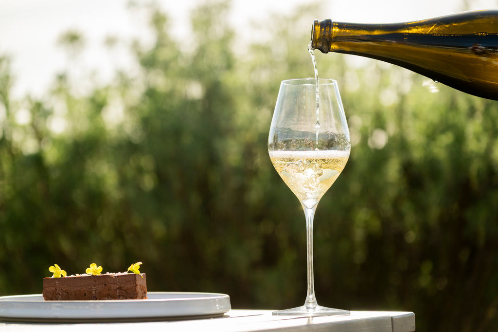 sipping sparkling wine into glass