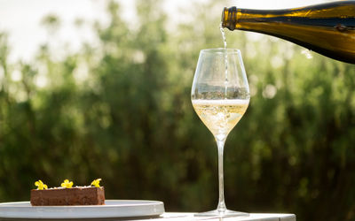 sipping sparkling wine into glass