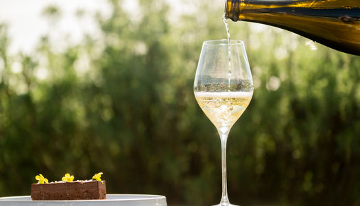 sipping sparkling wine into glass