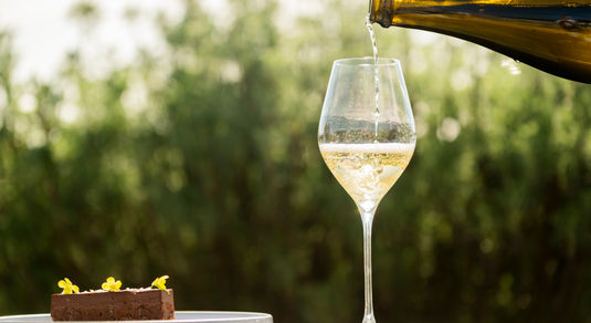 sipping sparkling wine into glass