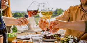 Diners raising their glasses alfresco at Artelium wine estate