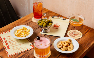 nibbles and cocktails served on the wooden table at bar 50ml